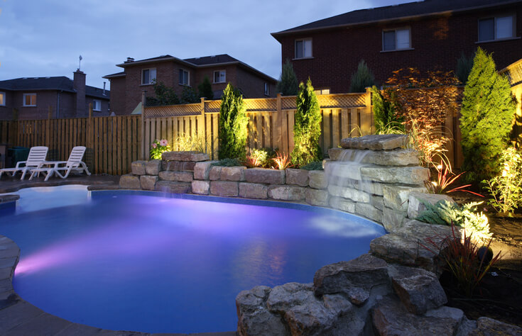 Evening lighting of a backyard and pool