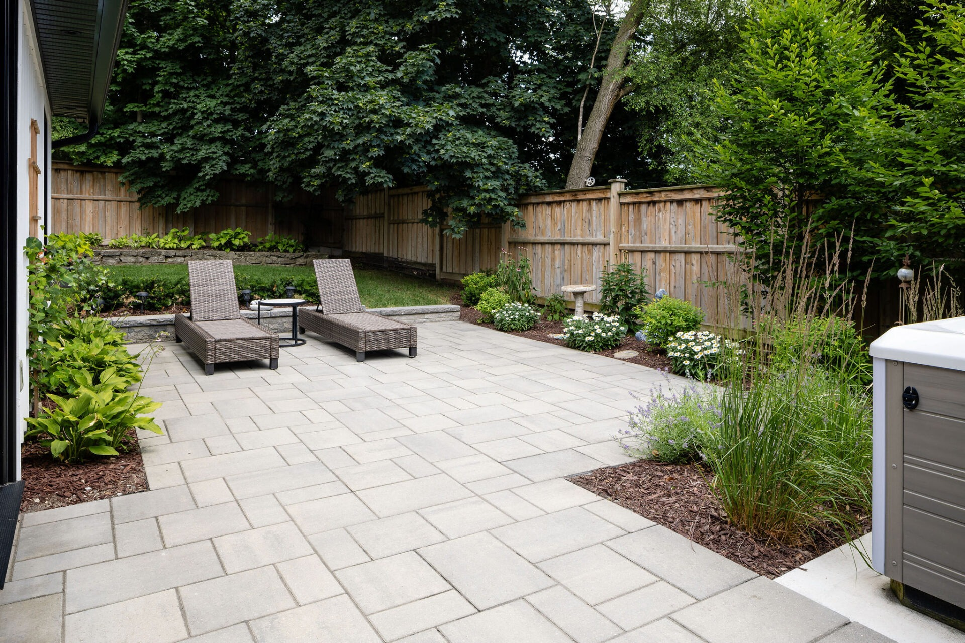 A backyard with a stone patio