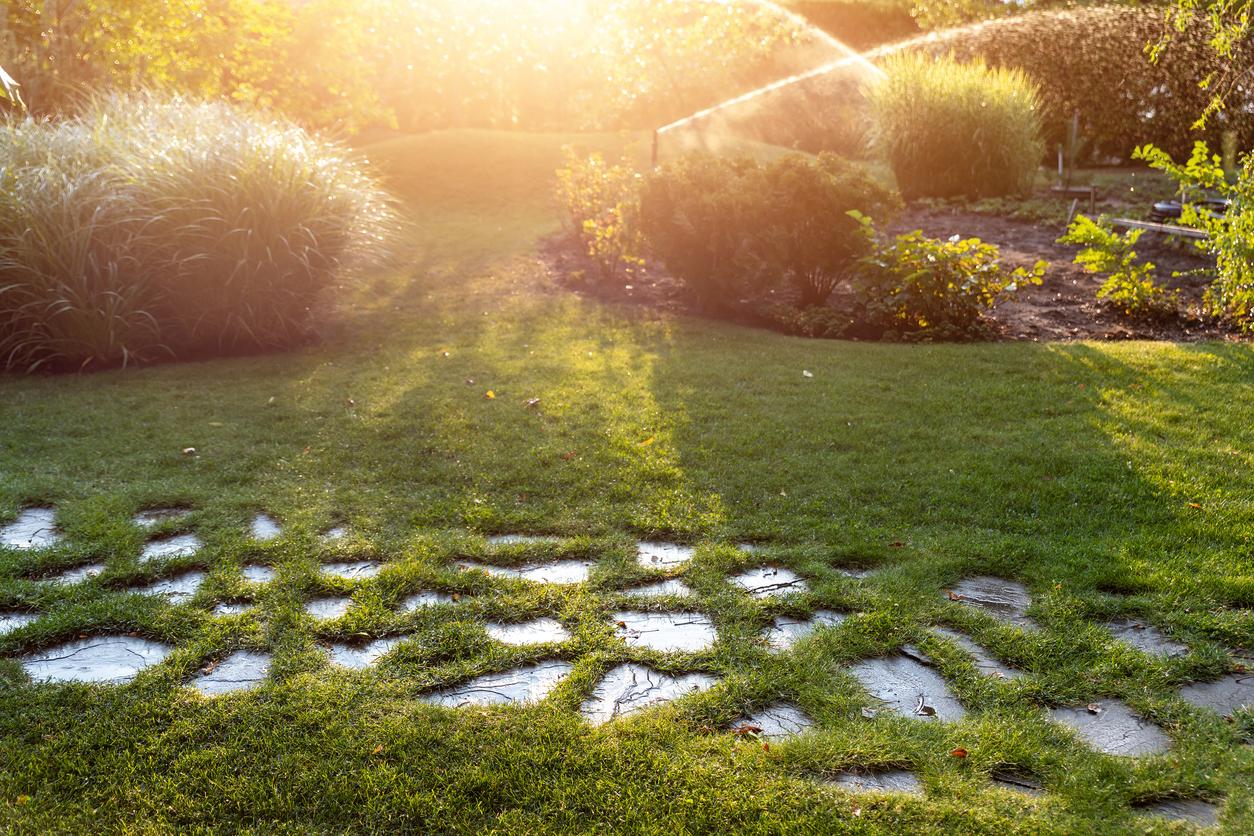 Smart irrigation watering a garden in the evening.